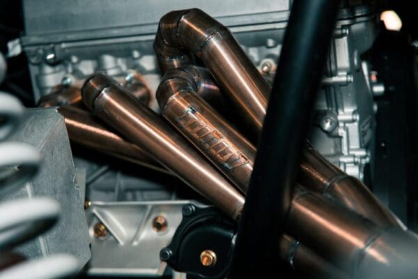 A close up of copper pipes and an engine