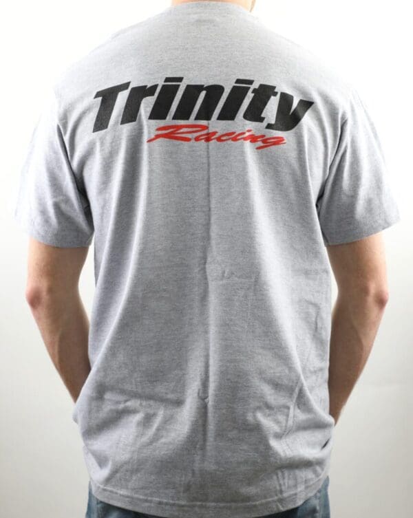 A person wearing a t-shirt with the word trinity racing on it.