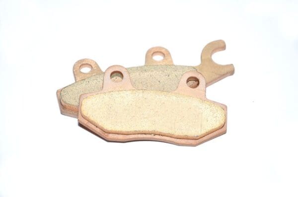 A pair of brake pads are sitting on top of each other.