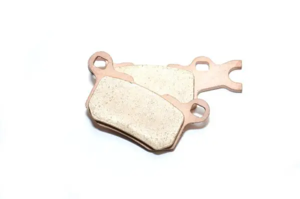 A pair of brake pads sitting on top of a white surface.