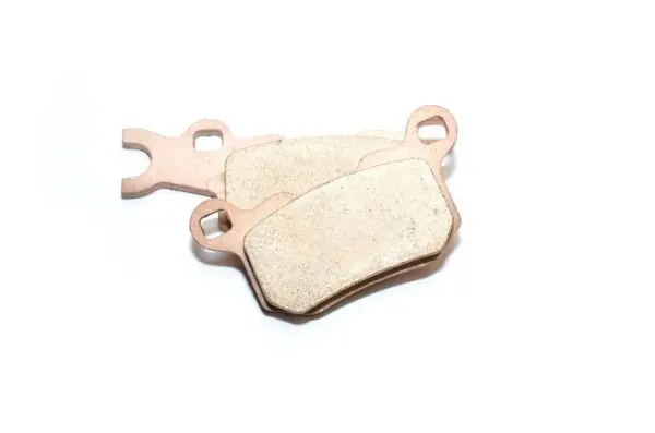 A pair of brake pads sitting on top of each other.