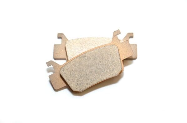 A pair of brake pads sitting on top of each other.