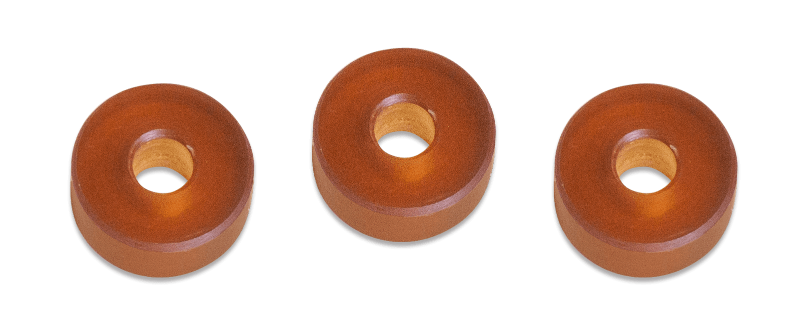 Three wooden donuts are shown in a row.