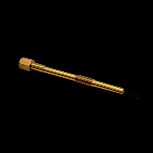 A gold colored metal tube with a black background