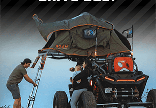 A man working on the back of an atv.